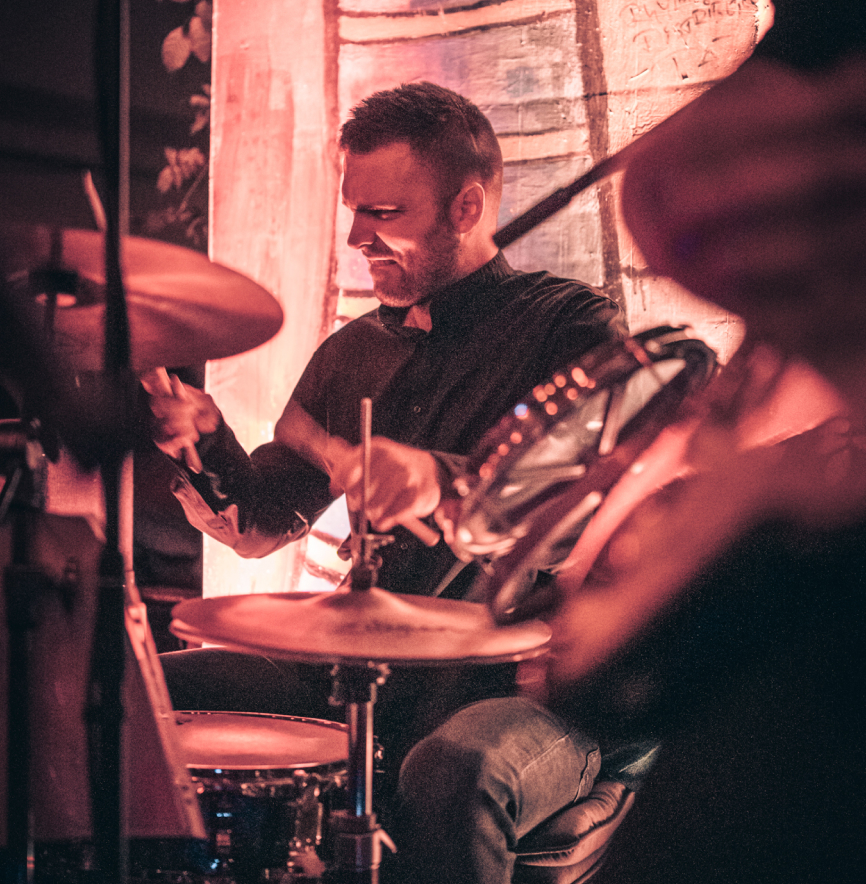 Jovan playing drums on stage