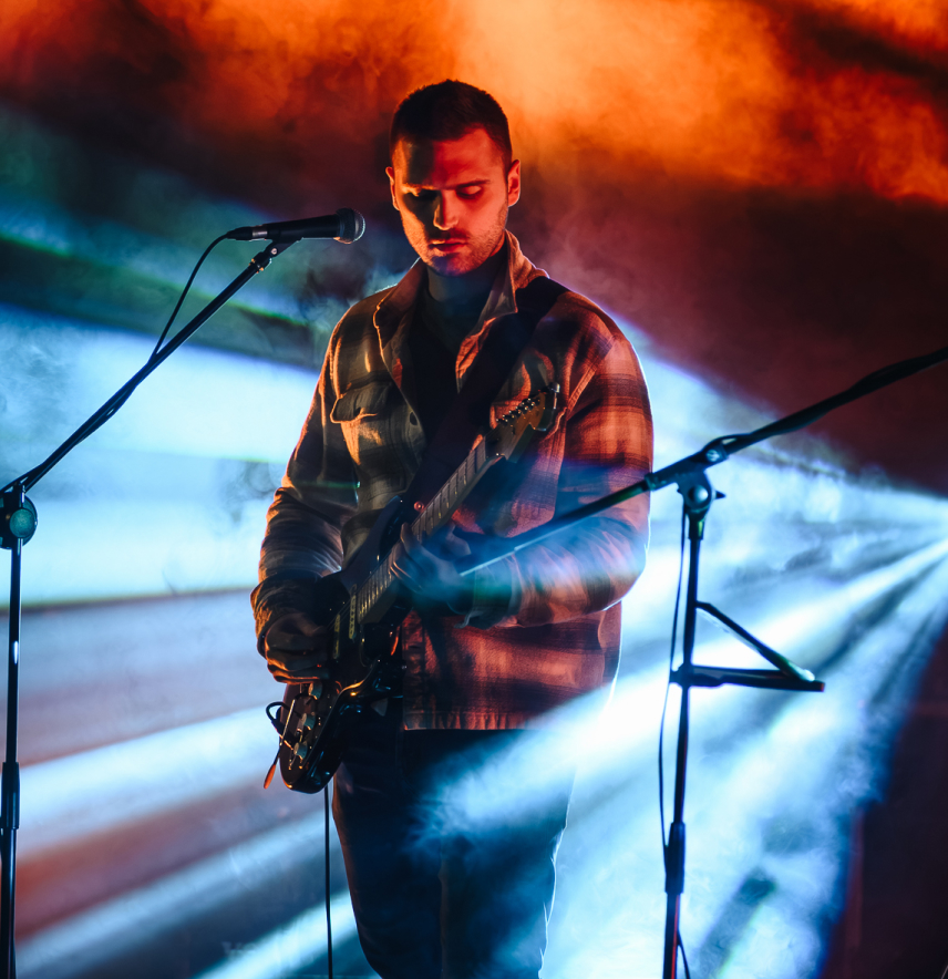 Jovan playing guitar on stage